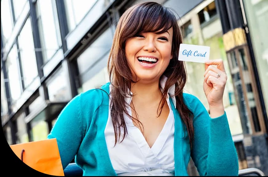 gift card program_woman smiling holding gift card