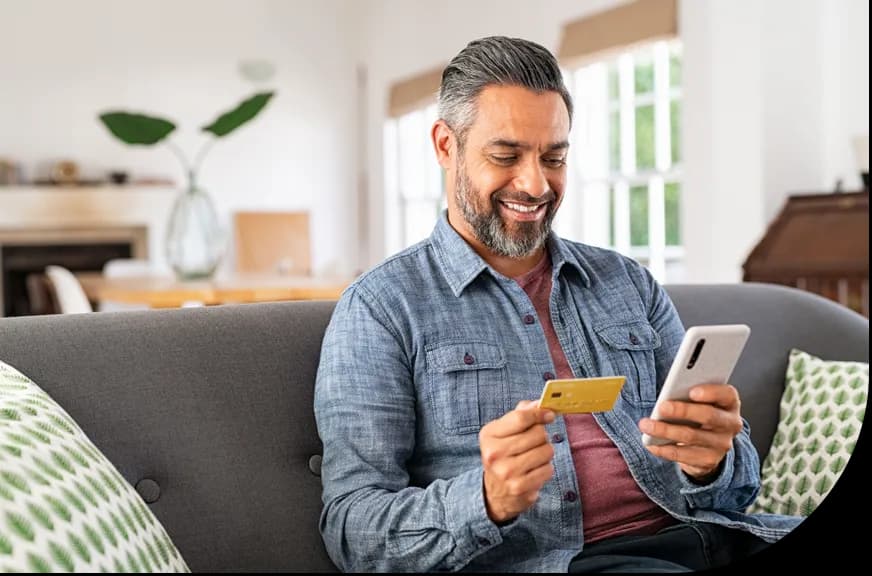 gift card program_man holding gift card using mobile device
